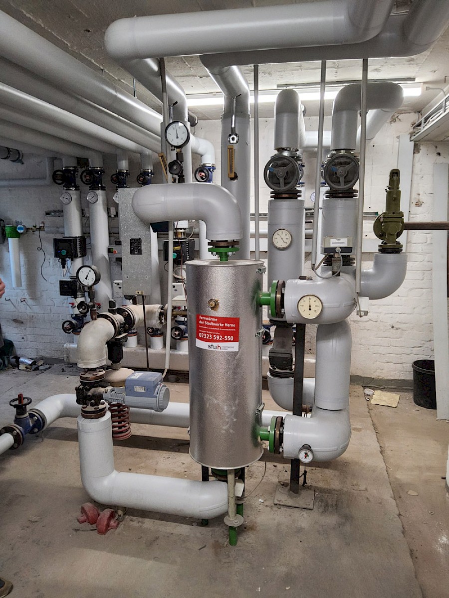 Heizungsraum mit vielen Rohren und Ventilen
